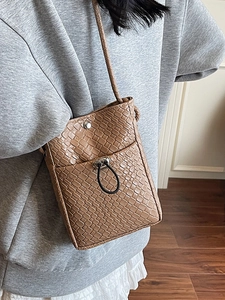 Brown woven crossbody phone bag with leather texture and drawstring pocket detail