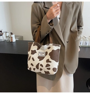 Detail view of the brown cow print corduroy tote bag showing material texture and strap