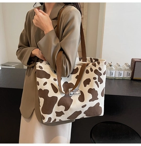 Close-up of cow print corduroy tote bag showing textured fabric and spacious design