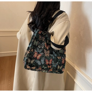 Detail of colorful butterfly jacquard pattern on black large capacity tote bag