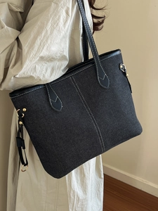 Large denim tote bag with contrast stitching and shoulder strap for women