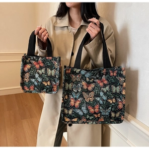 Detailed comparison of large and small butterfly jacquard tote bags with woven handles