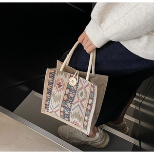 Close-up of ethnic woven pattern on tote bag with white cotton rope handles