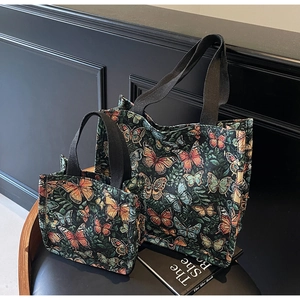 Close-up of butterfly jacquard weave on large tote bags set with black woven handles