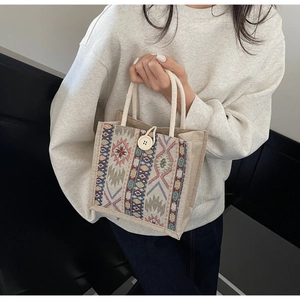 Detailed close-up of ethnic tote bag with geometric patterns and rope handles