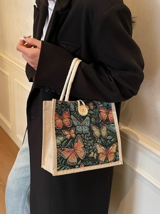 Linen butterfly pattern tote bag with woven rope handles and a wooden button closure