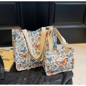 Detailed close-up of butterfly jacquard fabric and reinforced handles on tote bag