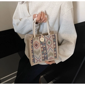 Detail of bohemian woven handbag with geometric patterns and large decorative button
