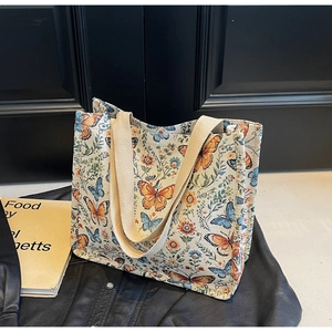 Close-up of the woven tapestry texture and vintage floral butterfly patterns on the tote bag