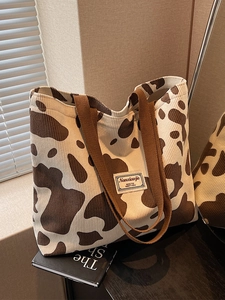 Stylish large capacity corduroy tote bag with cow print and dual brown handles