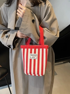 Chic red and white striped canvas bucket tote bag for casual everyday styling