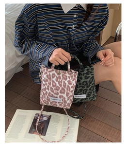 Detail view of mini leopard print canvas tote bags with adjustable crossbody straps