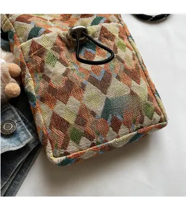 Macro shot of bohemian woven fabric texture with drawstring and plush charm detail