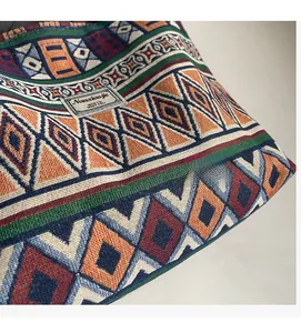 Detail of colorful geometric diamond woven canvas fabric with brand label on tote bag