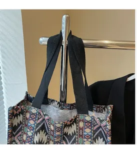 Detail of bohemian tote bag showing geometric jacquard weave and sturdy black straps