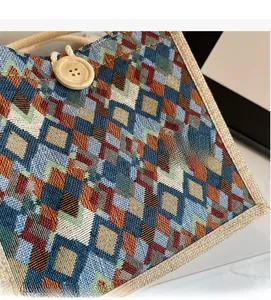 Close-up of geometric jacquard fabric with wooden button and linen trim details