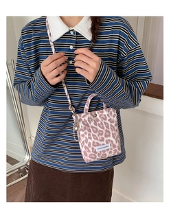 Detail of pink leopard print canvas crossbody bag with magnetic buckle and handle