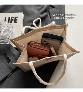 Spacious interior of linen tote bag showing phone, wallet and cosmetics inside