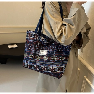 Bohemian canvas bucket tote bag detail with ethnic patterns and woven shoulder strap