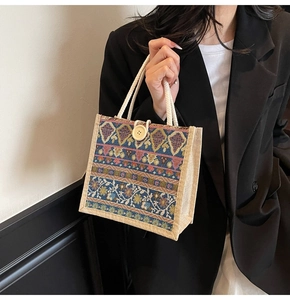 Ethnic style woven handbag featuring colorful geometric patterns and cotton rope handles