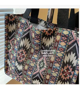 Close-up of colorful ethnic tapestry fabric and black canvas handle on large tote bag
