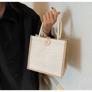 Detail of floral jacquard tote bag with white rose texture and rustic rope handle