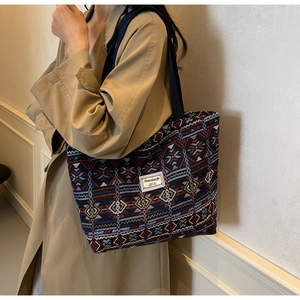 Detail of the ethnic geometric woven texture and durable canvas shoulder strap on the tote
