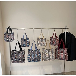 Detail of ethnic canvas tote bags in various sizes with bohemian geometric patterns