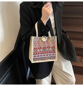 Close-up of Bohemian patterned handbag with ethnic embroidery and wooden button detail