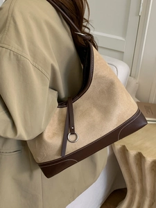 Retro beige suede and brown leather hobo shoulder bag styled with khaki trench coat