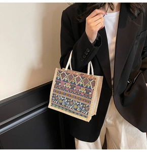 Close-up of bohemian tote bag featuring vintage floral patterns and braided rope handles