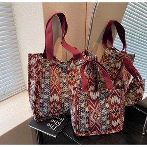 Macro shot of large and small bohemian woven tote bags with geometric patterns
