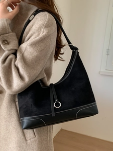 Matte black leather tote bag with white contrast stitching and metallic ring detail