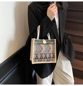 Close-up of woven tote bag with colorful ethnic patterns and sturdy rope handles