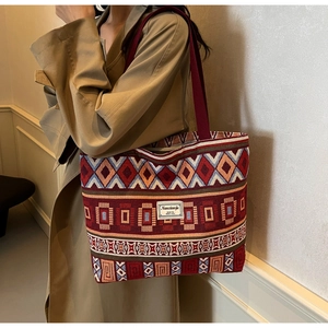 Detailed close-up of ethnic jacquard pattern on a large capacity canvas tote bag