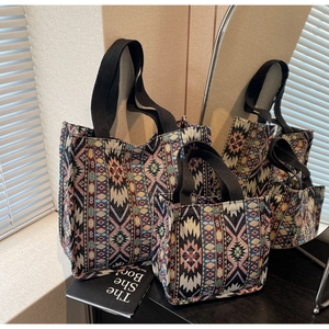 Detail of two-piece ethnic jacquard tote bags with complex geometric patterns
