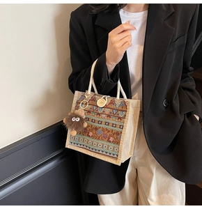 Close-up of ethnic style linen tote with colorful retro embroidery and wooden button detail