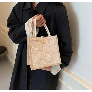 Detailed close-up of retro floral jacquard handbag with soft cotton rope handle and wood button
