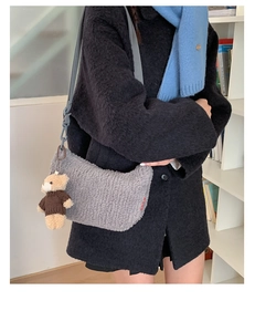 Détail du sac bandoulière croissant en peluche grise avec un joli pendentif ourson