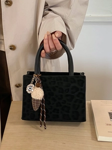 Retro leopard print tote bag with plush ice cream charm shown in a lifestyle setting