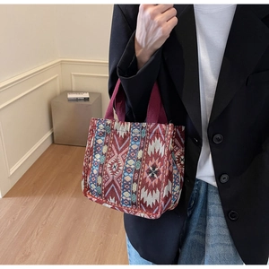 Detailed texture of ethnic woven tote bag with red and blue geometric patterns