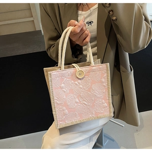 Pink jacquard tote with rose patterns, beige round buckle and woven rope handles