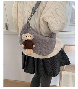 Détail du sac croissant en peluche grise avec pendentif ours et chaîne décorative