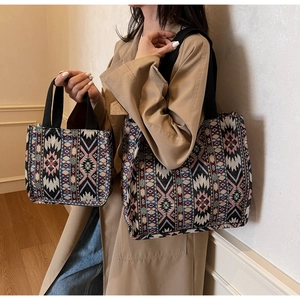 Detail of ethnic tote bags featuring colorful geometric woven patterns and black straps