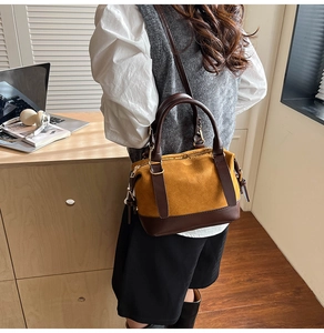 Detailed side view of the Boston pillow bag with contrast matte and leather texture