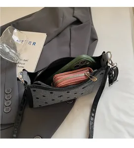 Spacious interior of polka dot shoulder bag showing capacity for phone and wallet