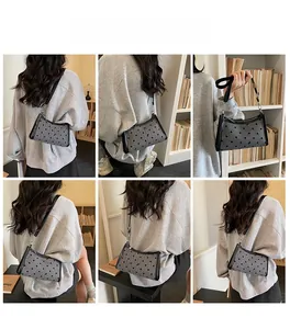 Detailed views of gray polka dot shoulder bag with bow and slim black straps on a model