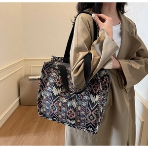 Detail of bohemian woven tote bag with geometric patterns and sturdy shoulder straps