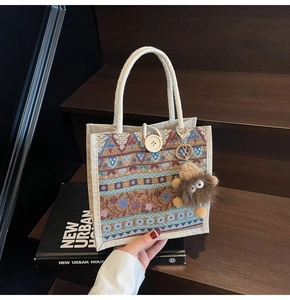 Close-up of ethnic tote bag with vintage geometric patterns and a wooden button closure