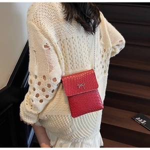 Red crocodile texture shoulder bag with silver bow detail and thin metal chain strap